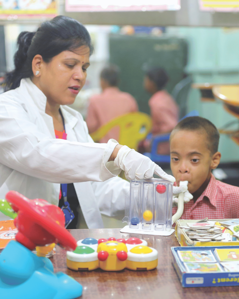 An instructor and student in the Bal Chetna program completing a spirometry test