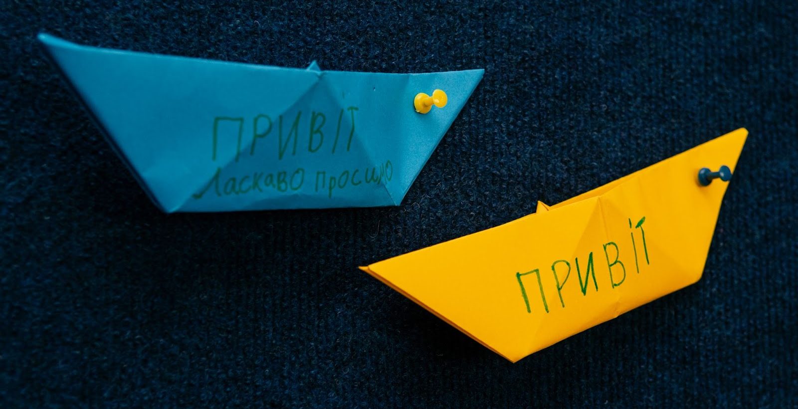 Paper boats with Hello written on them in Ukrainian