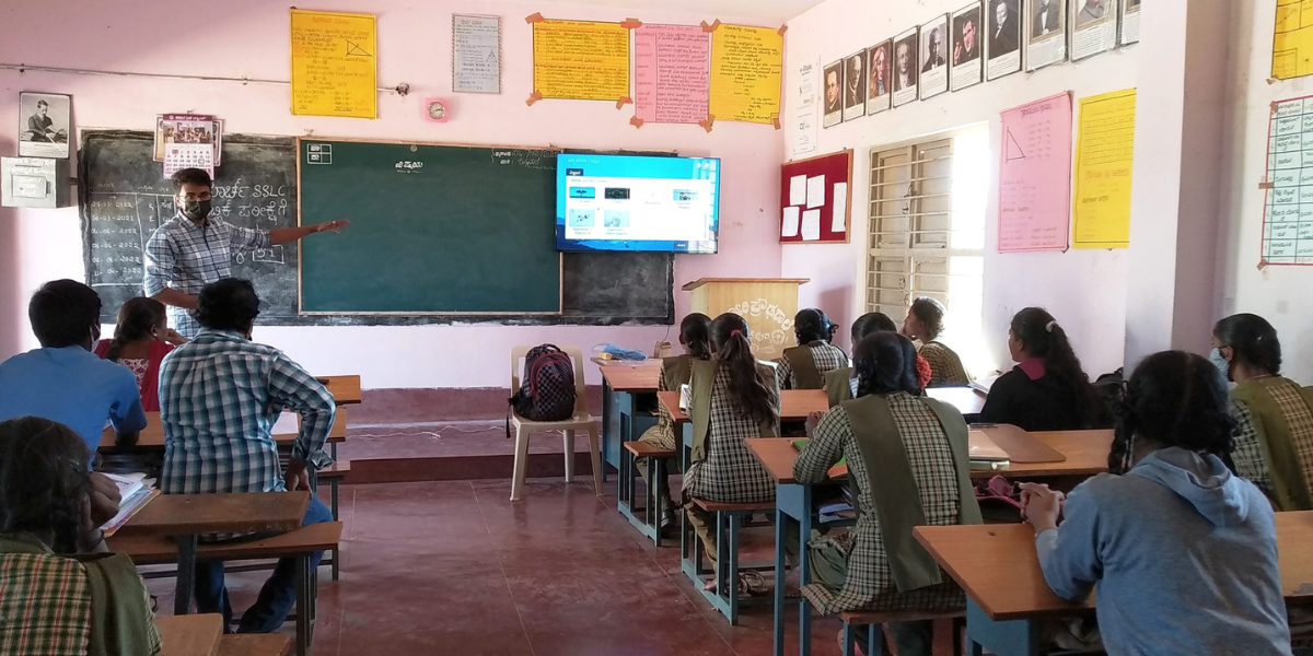 Students and a teacher in a classroom at GHS Valagerepura in Kunigal, Karnataka, India - Developing Digital Learning in India
