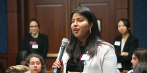 Woman speaking into microphone - Cultivating the Next Generation of Women Leaders